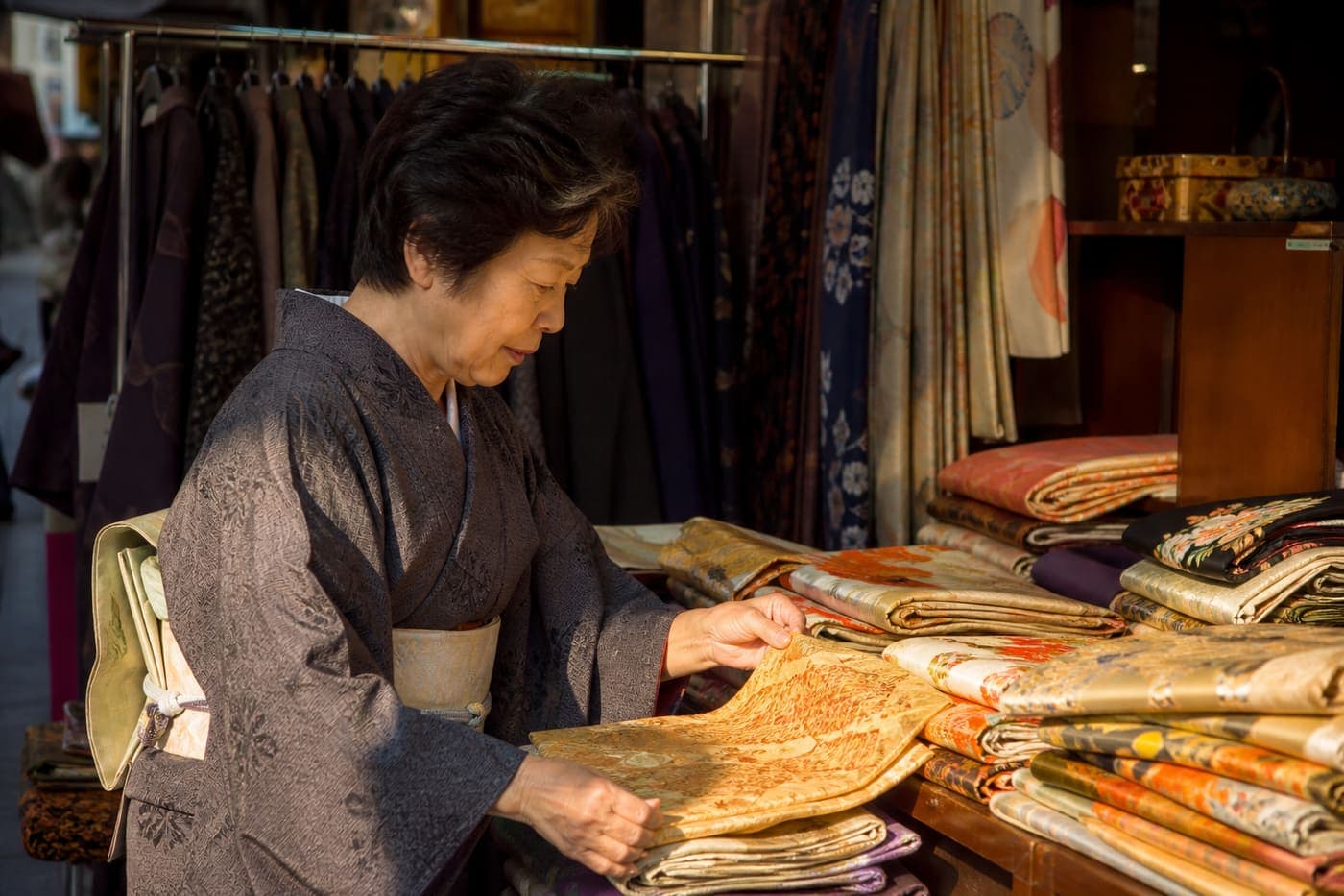 Hakata vendor arranging vintage obi